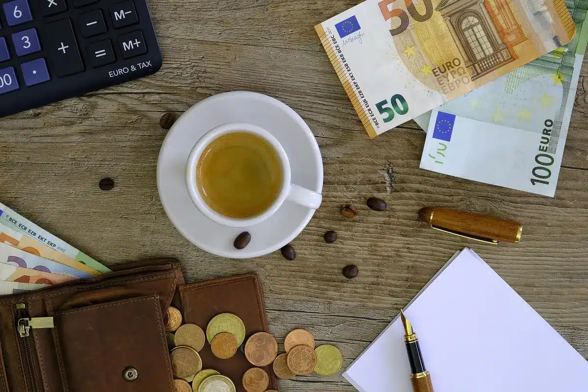 clean desk with currency calculator and scattered silver coins blurred in background